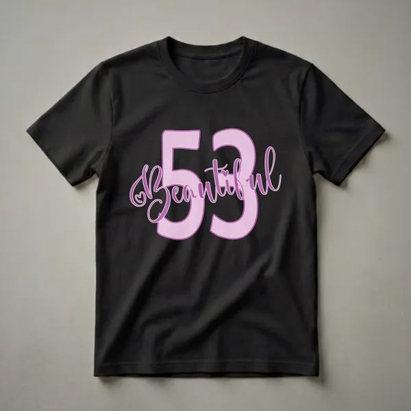 A graphic t-shirt design featuring large pastel pink numbers '53' with the word 'Beautiful' in purple script, and a small purple heart detail.