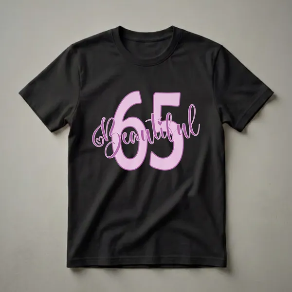 Light pink graphic t-shirt with purple text that reads 'Beautiful 65' with a heart accent.
