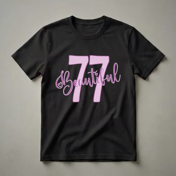 Lavender and purple graphic t-shirt with the number 77 and the word Beautiful in script font, with a small heart accent.