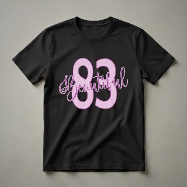 Light pink graphic t-shirt with the number 83 and the word 'Beautiful' in script font, featuring a small heart detail.