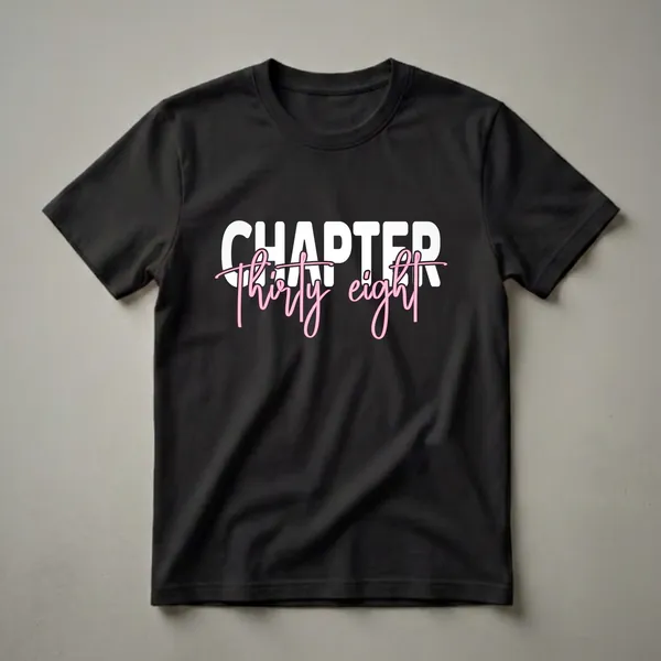 Black t-shirt with white block text reading 'CHAPTER' and pink cursive text reading 'Thirty eight' below it, celebrating a 38th birthday.
