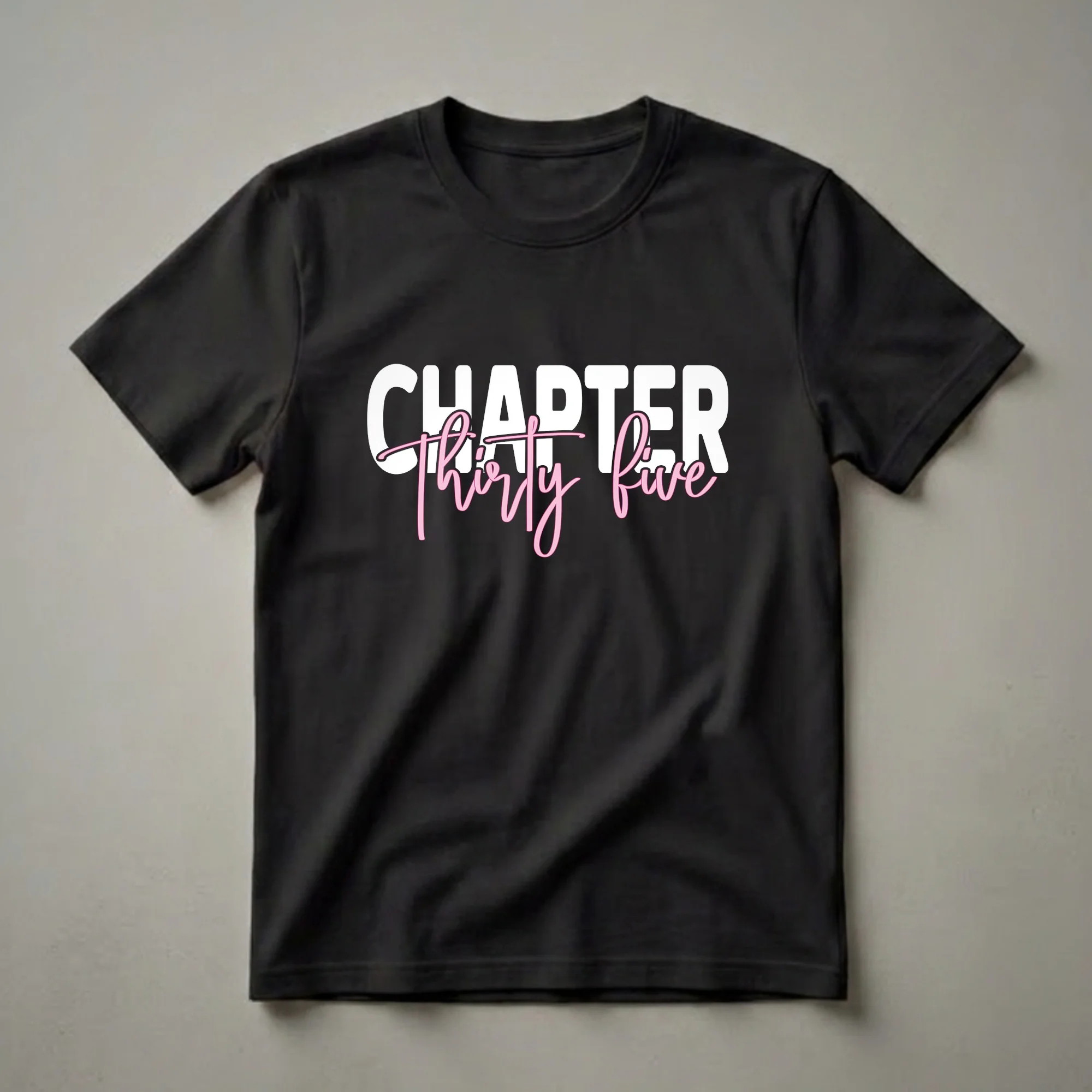 Black t-shirt with white block text 'CHAPTER' above pink script text 'Thirty five', celebrating a 35th birthday.