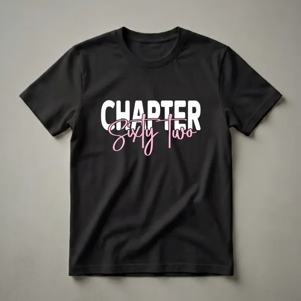 Black t-shirt with white block letters spelling 'CHAPTER' above pink script spelling 'Sixty Two', celebrating a 62nd birthday.