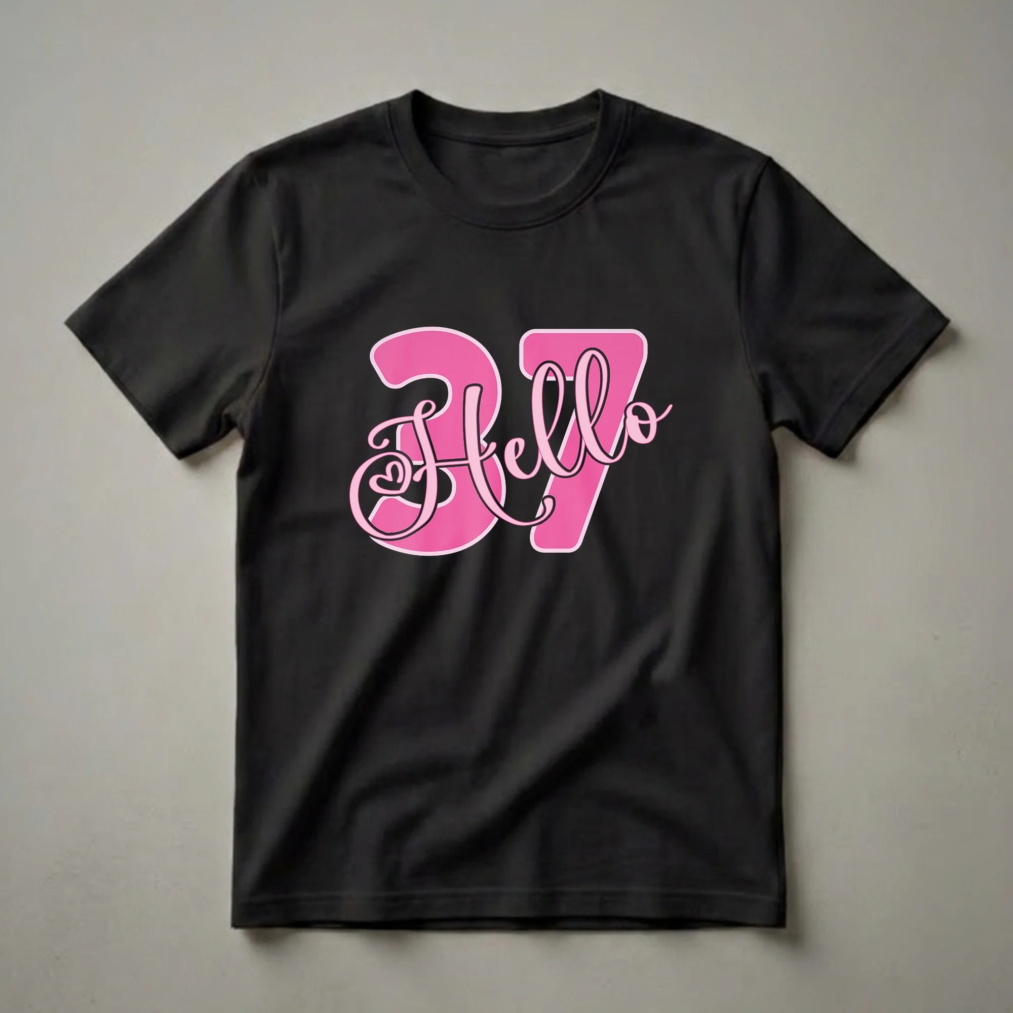 Black t-shirt with a large pink graphic that says 'Hello 37' in a combination of script and block fonts, with a pink outline and black shadow.