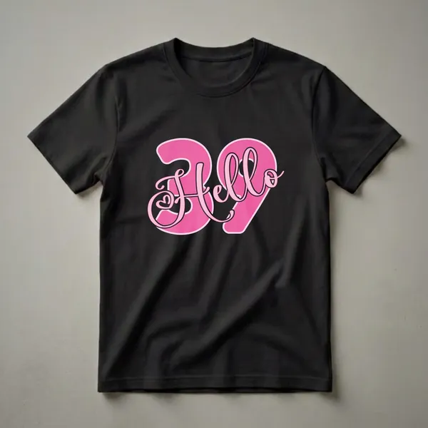 Black t-shirt with a large pink graphic that says 'Hello 39' in a stylized font, with a small heart detail.