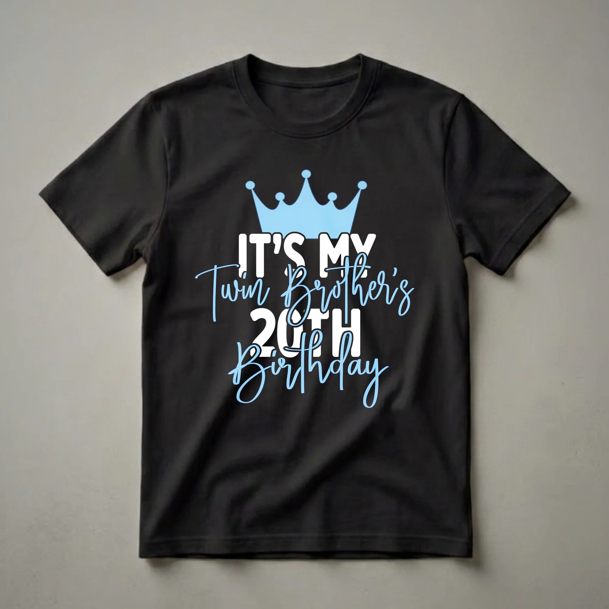 Black t-shirt with a light blue crown graphic and white and light blue text that reads 'IT'S MY Twin Brother's 20TH Birthday'.