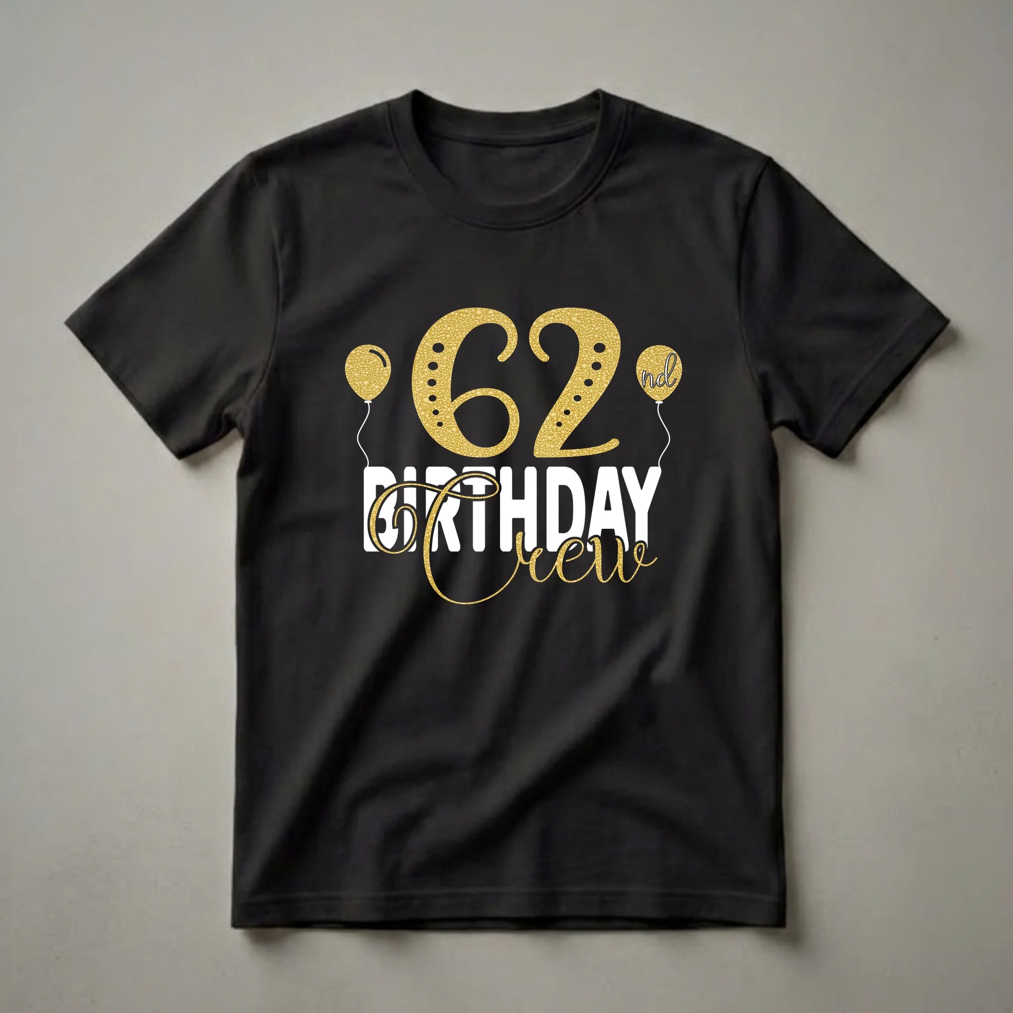 Black t-shirt with gold glitter "62" and "Crew" text, plus white "BIRTHDAY" text and gold glitter balloons.