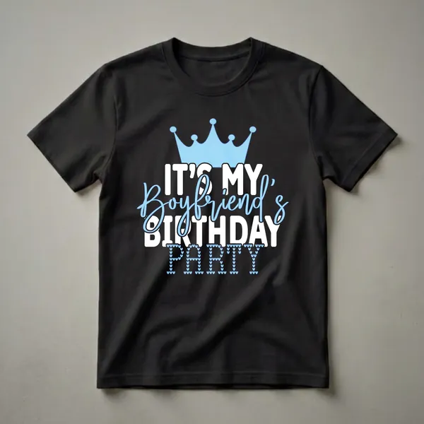 Black t-shirt with a light blue crown and white text that reads 'IT'S MY Boyfriend's BIRTHDAY PARTY', with the word 'PARTY' formed by small light blue hearts.
