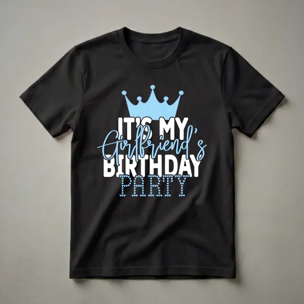 A graphic t-shirt with a light blue crown, white text reading 'IT'S MY BIRTHDAY', light blue cursive text reading 'Girlfriend's', and the word 'PARTY' formed by light blue hearts.