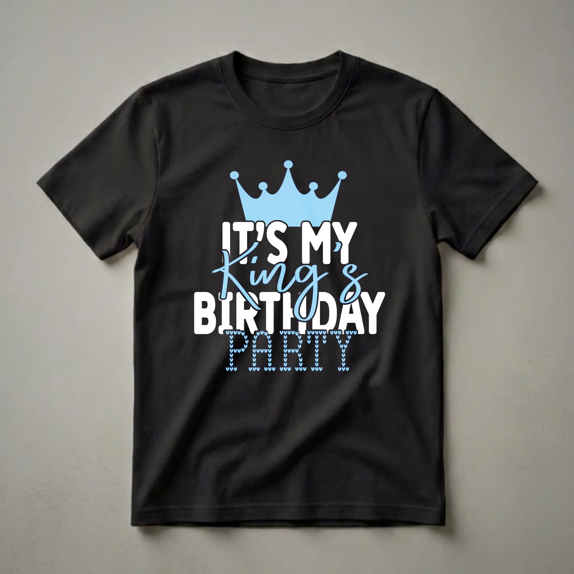 Black t-shirt with white and light blue text that reads 'IT'S MY King's BIRTHDAY PARTY', topped with a light blue crown and the word 'PARTY' formed by small hearts.