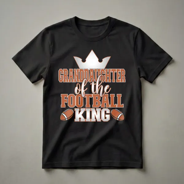 Black t-shirt with orange and white text reading "Granddaughter of the Football King" and two football graphics.