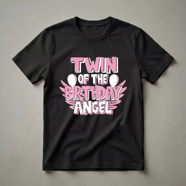 Black t-shirt with pink and white 3D text reading 'TWIN OF THE BIRTHDAY ANGEL', accented with white balloons and pink wings.