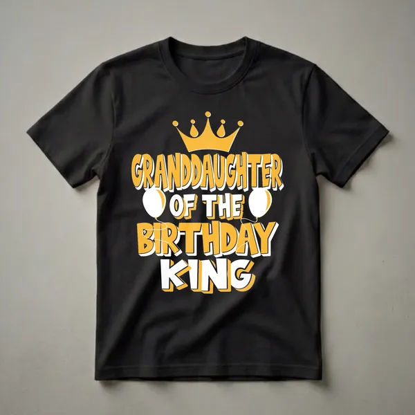 Black t-shirt with yellow and white text reading 'GRANDDAUGHTER OF THE BIRTHDAY KING', topped with a golden crown and flanked by white balloons.