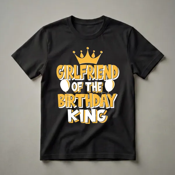 Black t-shirt with yellow and white text that reads 'Girlfriend of the Birthday King', topped with a golden crown and flanked by white balloons.