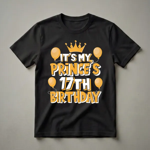 Black t-shirt with orange and white text that reads 'IT'S MY PRINCE'S 17TH BIRTHDAY', topped with a golden crown and surrounded by orange balloons.