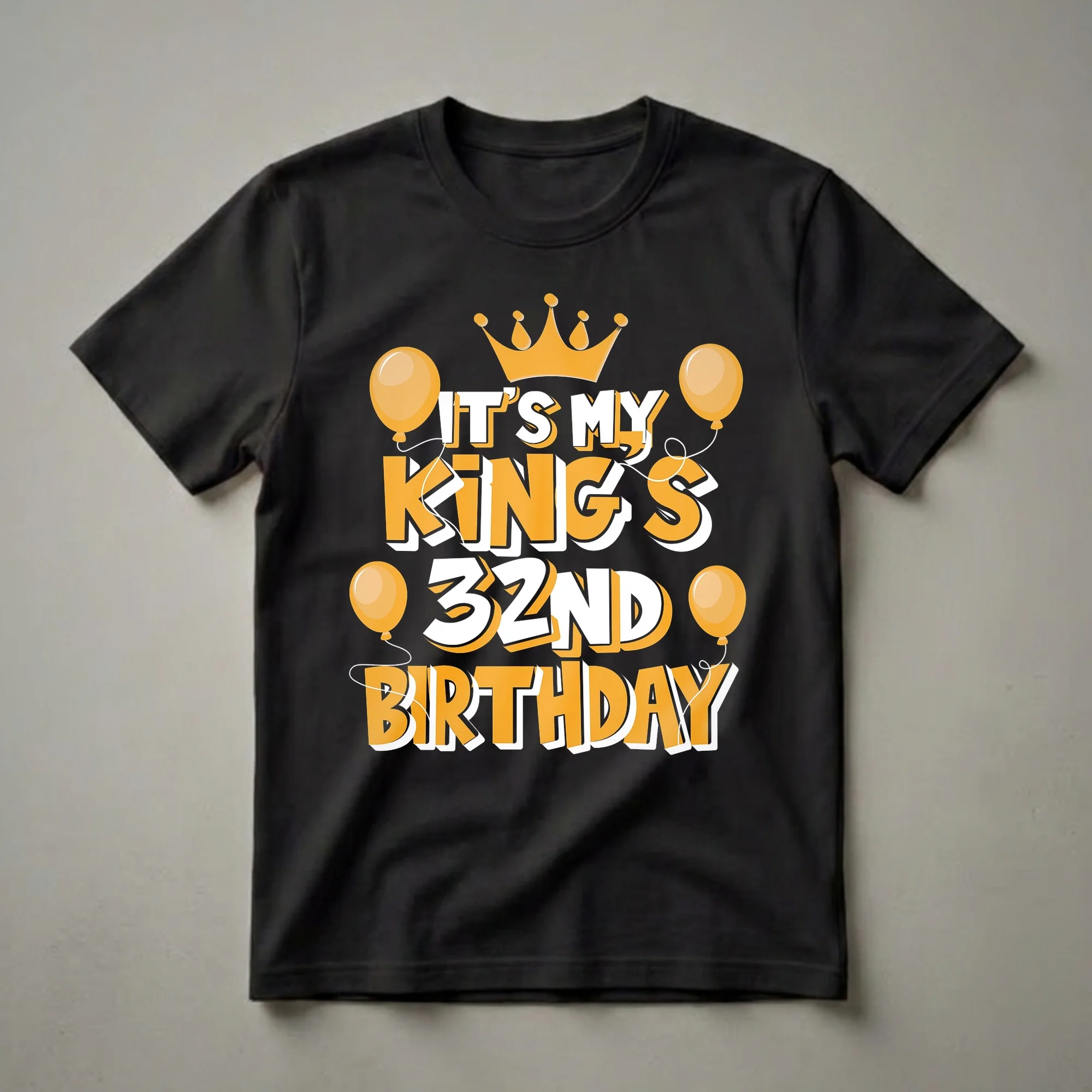 Black t-shirt with orange and white text reading 'IT'S MY KING'S 32ND BIRTHDAY', a golden crown, and orange balloons.