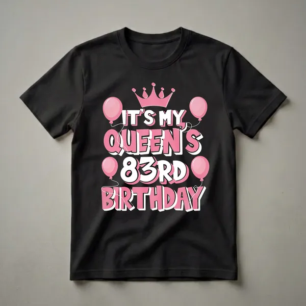 Black t-shirt with pink crown and balloons graphic, featuring bold white and pink text that reads 'IT'S MY QUEEN'S 83RD BIRTHDAY'.