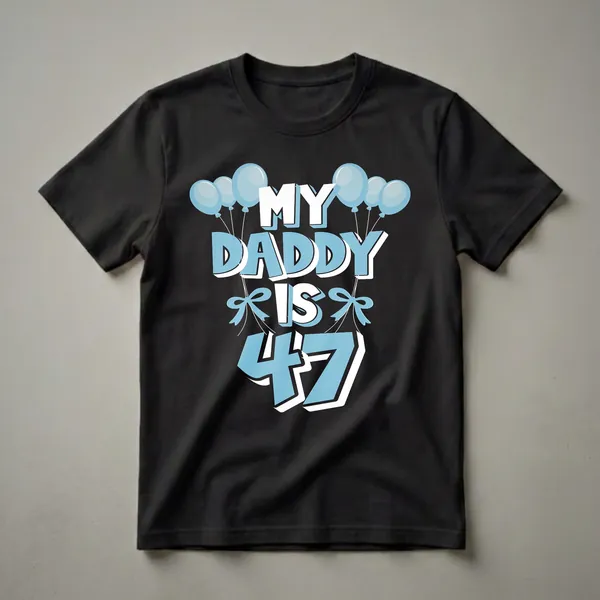 Black t-shirt with light blue and white text that reads "MY DADDY IS 47", adorned with light blue balloons and bows.