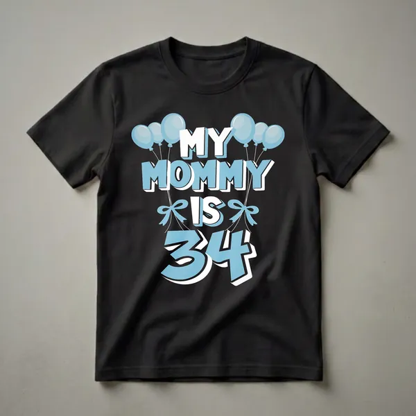 A black t-shirt with the text 'MY MOMMY IS 34' in white and light blue, adorned with light blue balloons and bows.