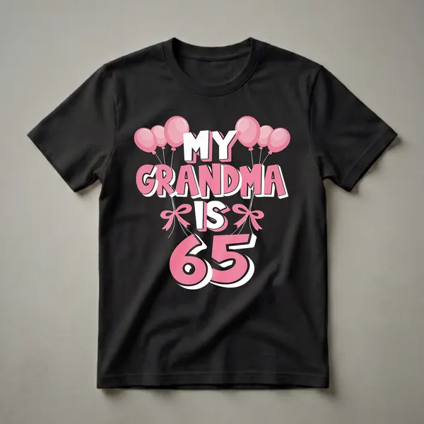 Black t-shirt with pink and white text that reads "MY GRANDMA IS 65" surrounded by pink balloons and pink bows.