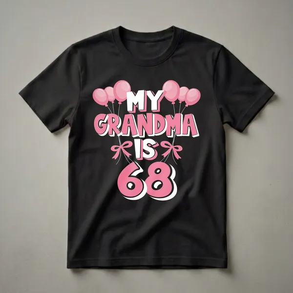 Black t-shirt with pink and white text that reads 'MY GRANDMA IS 68' surrounded by pink balloons and pink bows.