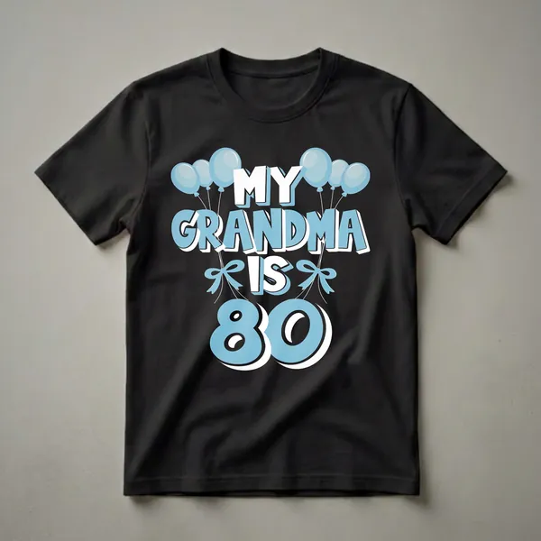Light blue graphic t-shirt with white and light blue text that reads "MY GRANDMA IS 80" surrounded by light blue balloons and bows.