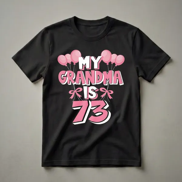 Black t-shirt with pink and white text that reads "MY GRANDMA IS 73" surrounded by pink balloons and pink bows.