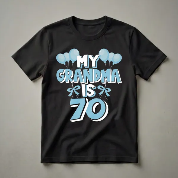 Light blue and white graphic t-shirt with black background, featuring the text 'MY GRANDMA IS 70' surrounded by blue balloons and bows.