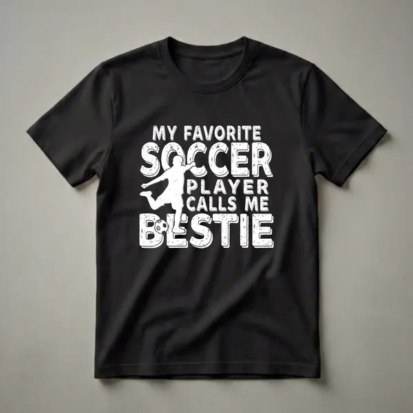 White distressed graphic t-shirt with the text 'My Favorite Soccer Player Calls Me Bestie' and a silhouette of a soccer player kicking a ball.