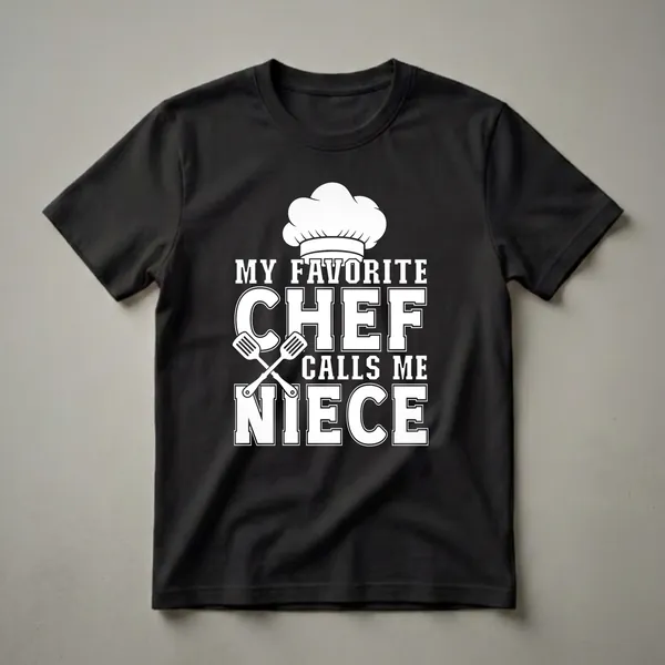 Black t-shirt with white graphic text that reads 'MY FAVORITE CHEF CALLS ME NIECE' and includes a chef's hat and crossed spatulas.
