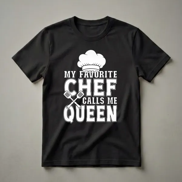 Black t-shirt with white graphic text that reads 'My Favorite Chef Calls Me Queen' and includes a chef's hat and crossed spatulas.