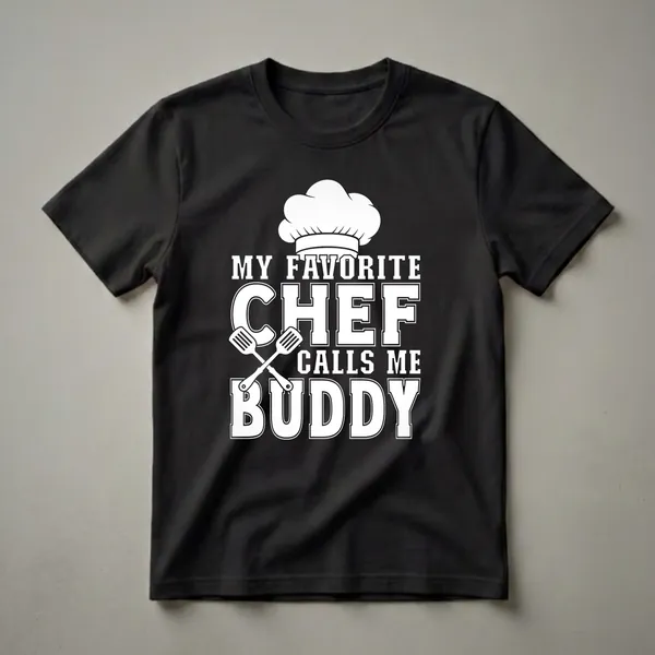 Black t-shirt with white text that reads 'My Favorite Chef Calls Me Buddy' and features a chef's hat and crossed spatulas.