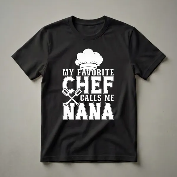 Black t-shirt with white graphic text that reads 'MY FAVORITE CHEF CALLS ME NANA' and includes a chef's hat and crossed spatulas.