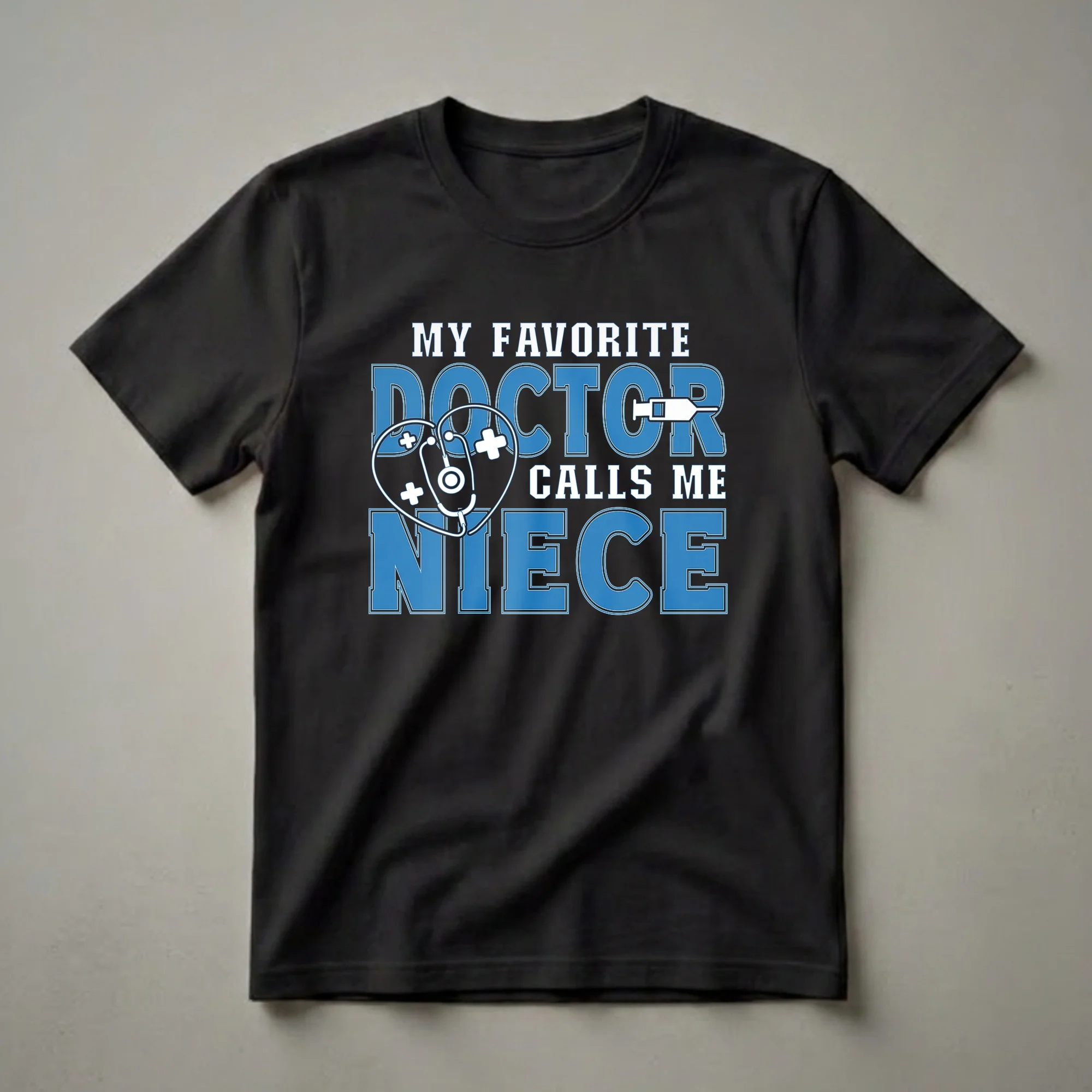 Black t-shirt with blue and white text that reads 'MY FAVORITE DOCTOR CALLS ME NIECE', featuring a stethoscope heart and a syringe graphic.