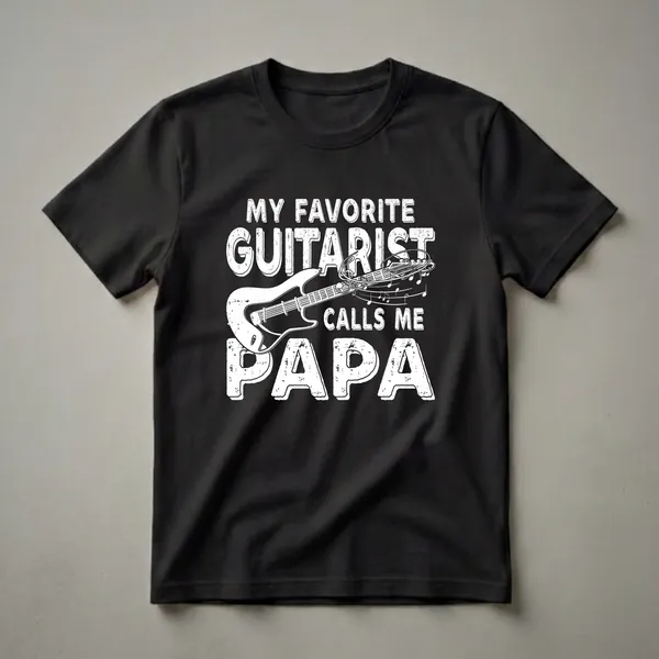 White graphic t-shirt featuring the text 'MY FAVORITE GUITARIST CALLS ME PAPA' with a stylized electric guitar and musical notes.