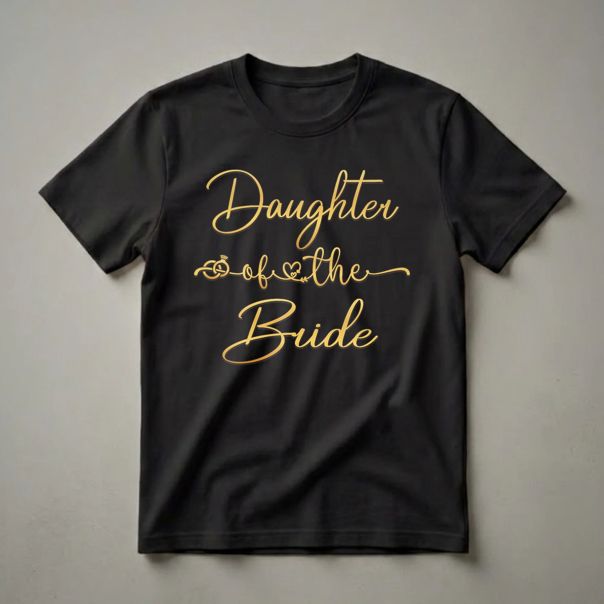 Black t-shirt with gold script text 'Daughter of the Bride' and graphics of a wedding ring and a heart.