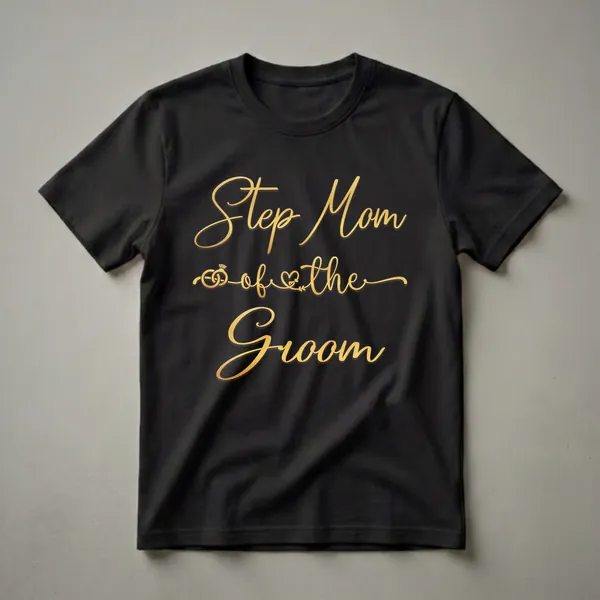 Black t-shirt with gold script text that reads 'Step Mom of the Groom' and features a graphic of wedding rings and a heart.