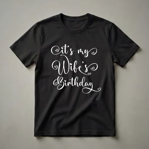 Black t-shirt with white cursive text that reads 'It's my Wife's Birthday' with small heart embellishments.