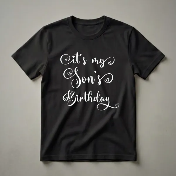 Black t-shirt with white cursive text that reads 'It's My Son's Birthday' and small heart accents.