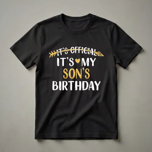 Black t-shirt with white and gold text that reads 'It's Official It's My Son's Birthday', featuring a gold arrow and a gold heart.