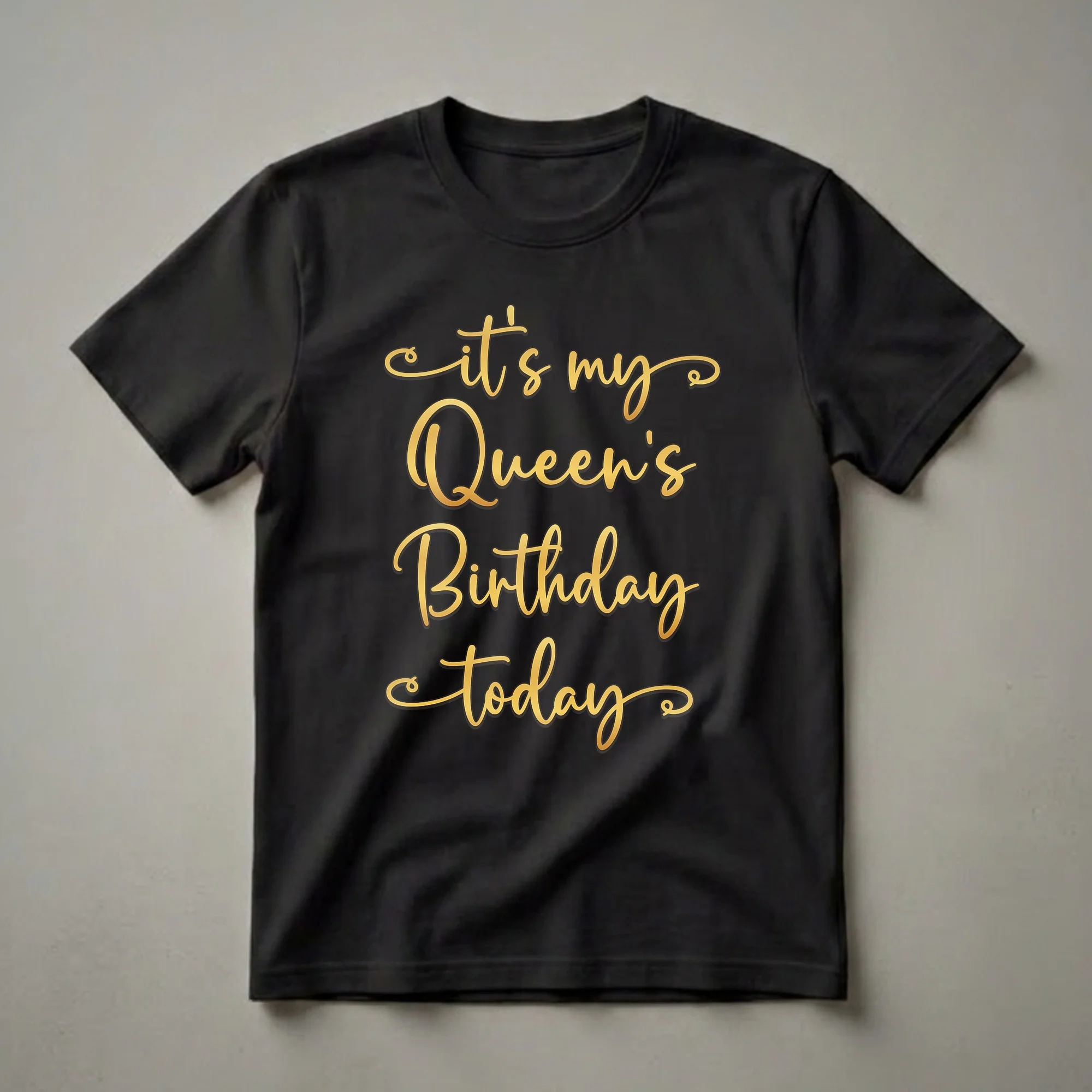 Black t-shirt with gold script text that reads 'it's my Queen's Birthday today'.
