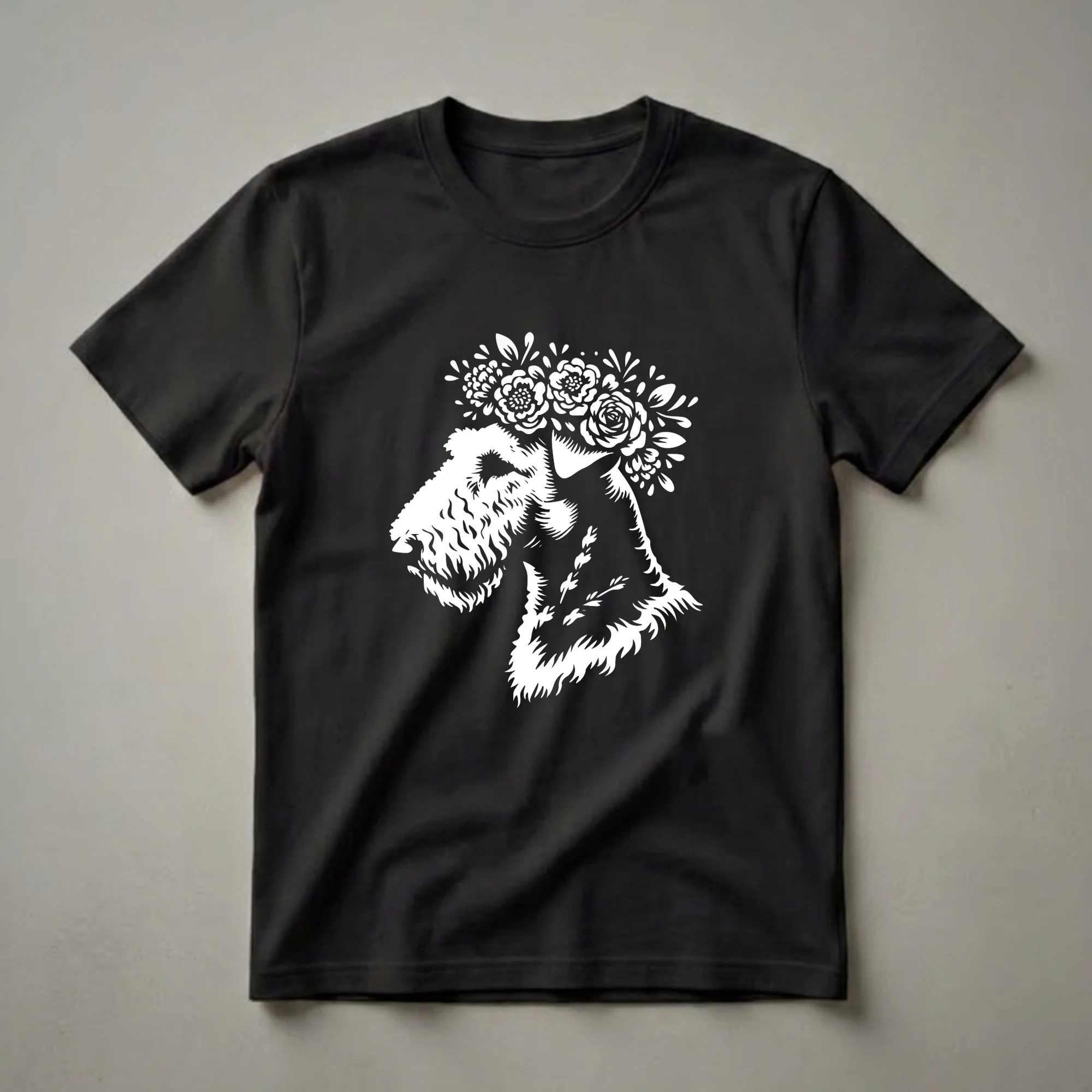 White graphic of an Airedale Terrier wearing a crown of flowers, set against a black background. This t-shirt design is ideal for dog lovers.
