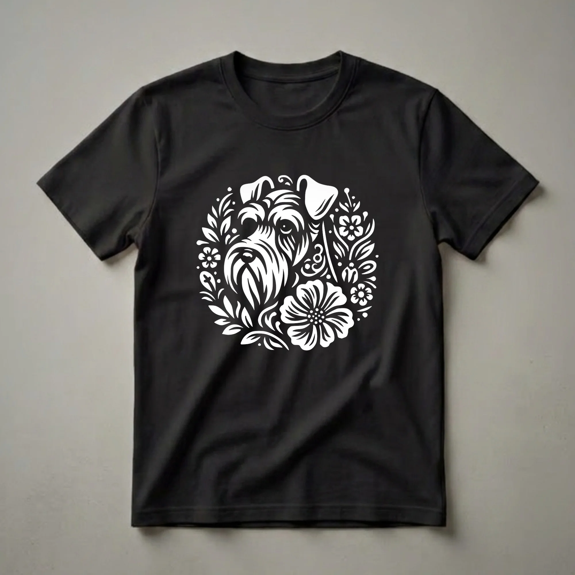 White graphic of a Miniature Schnauzer's face surrounded by flowers and leaves, on a black t-shirt.