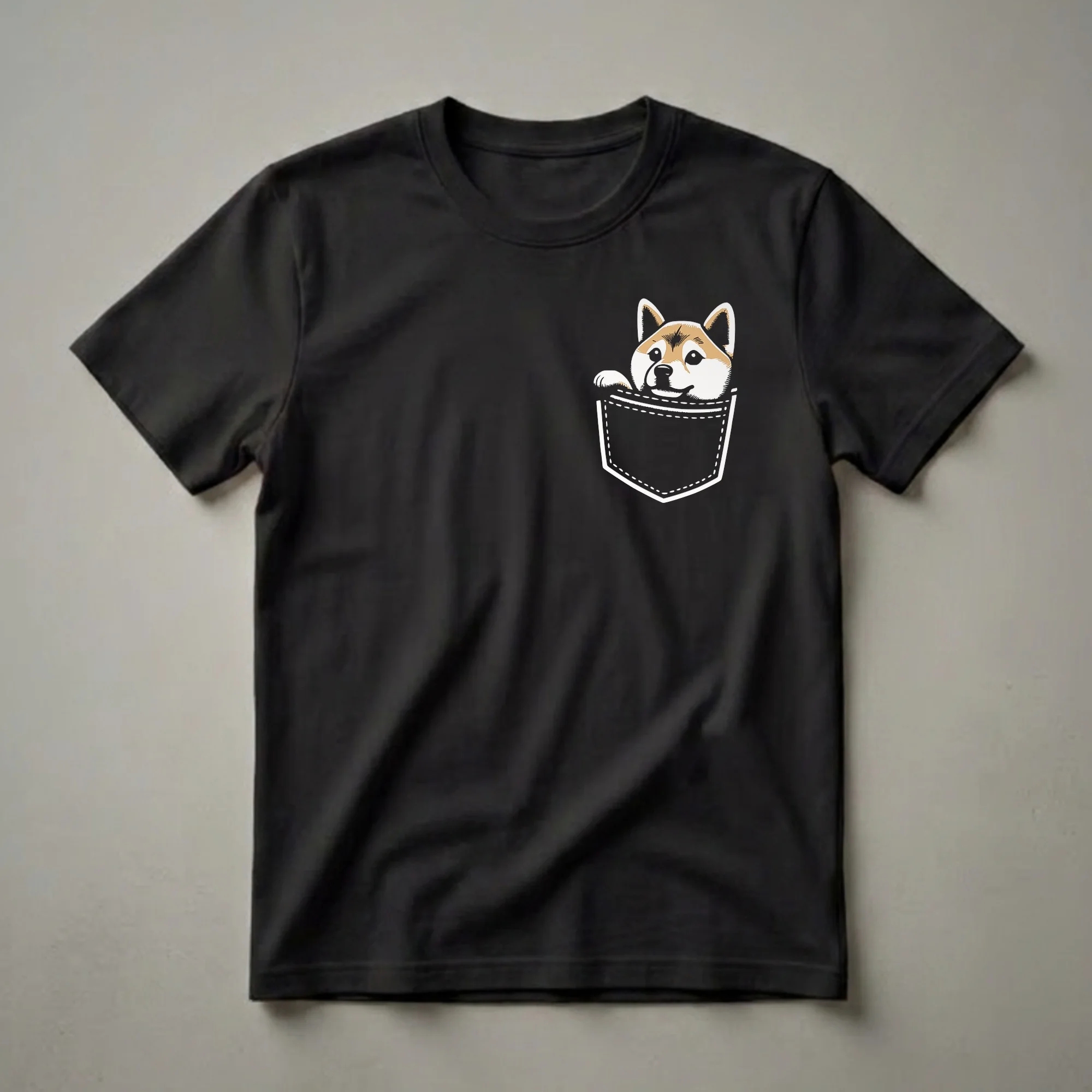 Black t-shirt featuring a cartoon Shiba Inu dog peeking out of a white stitched pocket with a happy expression.