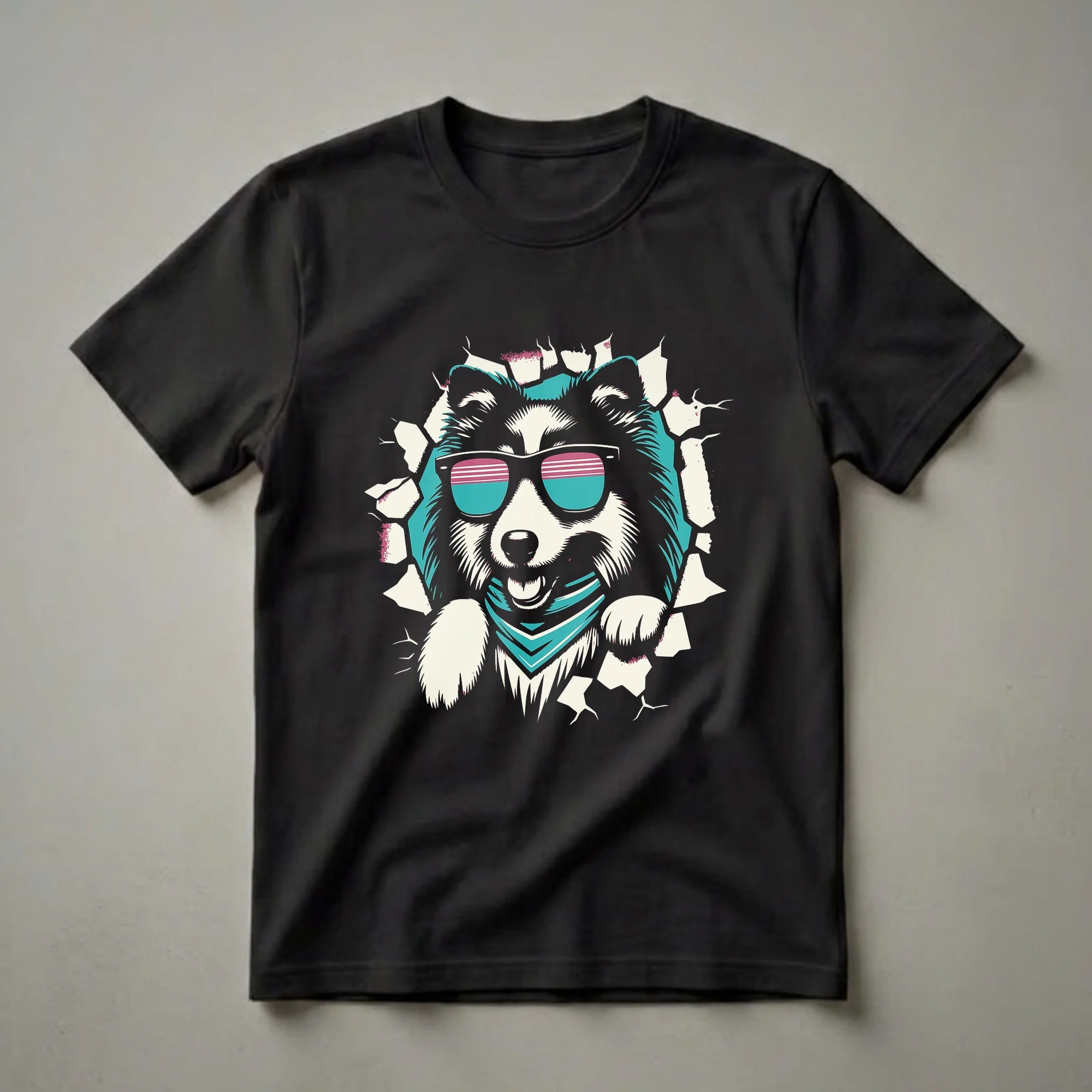 Black t-shirt featuring a graphic of a Shetland Sheepdog wearing retro sunglasses and a teal bandana, breaking through a cracked background.