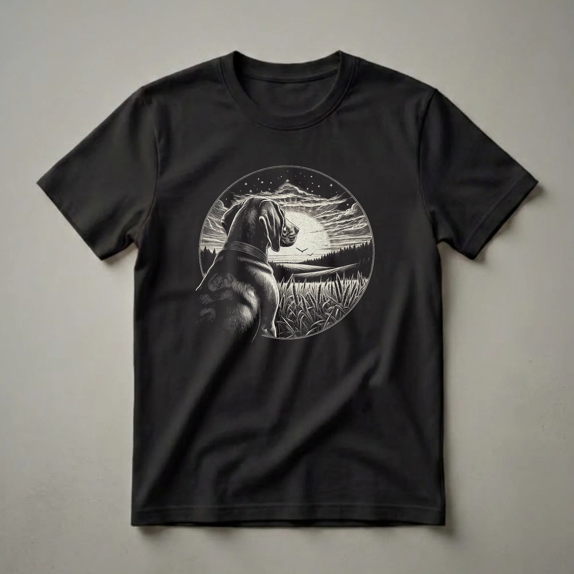 Black graphic t-shirt featuring a vintage illustration of a Coonhound dog looking at a moonlit landscape with wheat fields and silhouetted trees.
