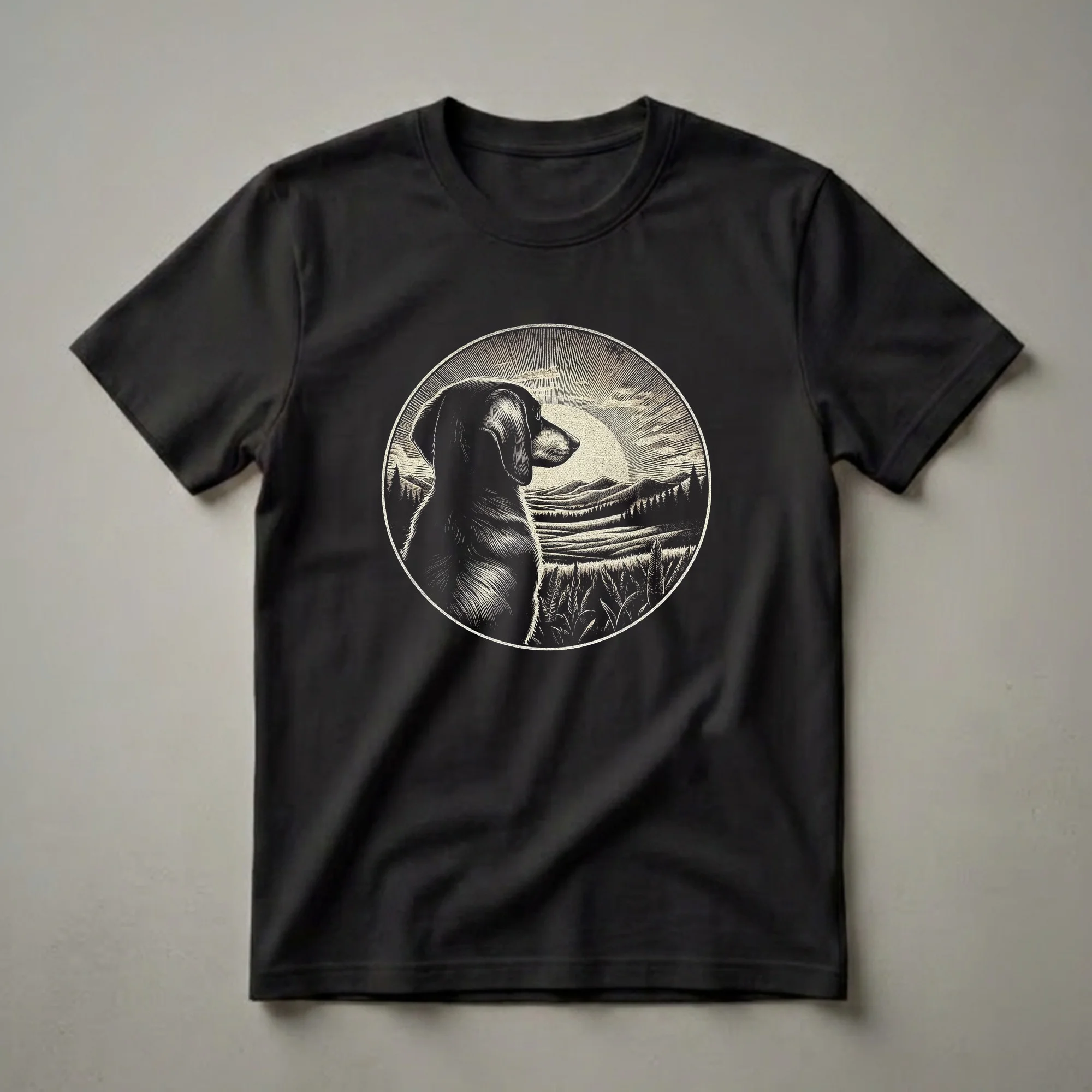 Black and white retro graphic t-shirt featuring a dachshund in profile looking at a sunset landscape with rolling hills, pine trees, and wheat in the foreground, all within a circular frame.