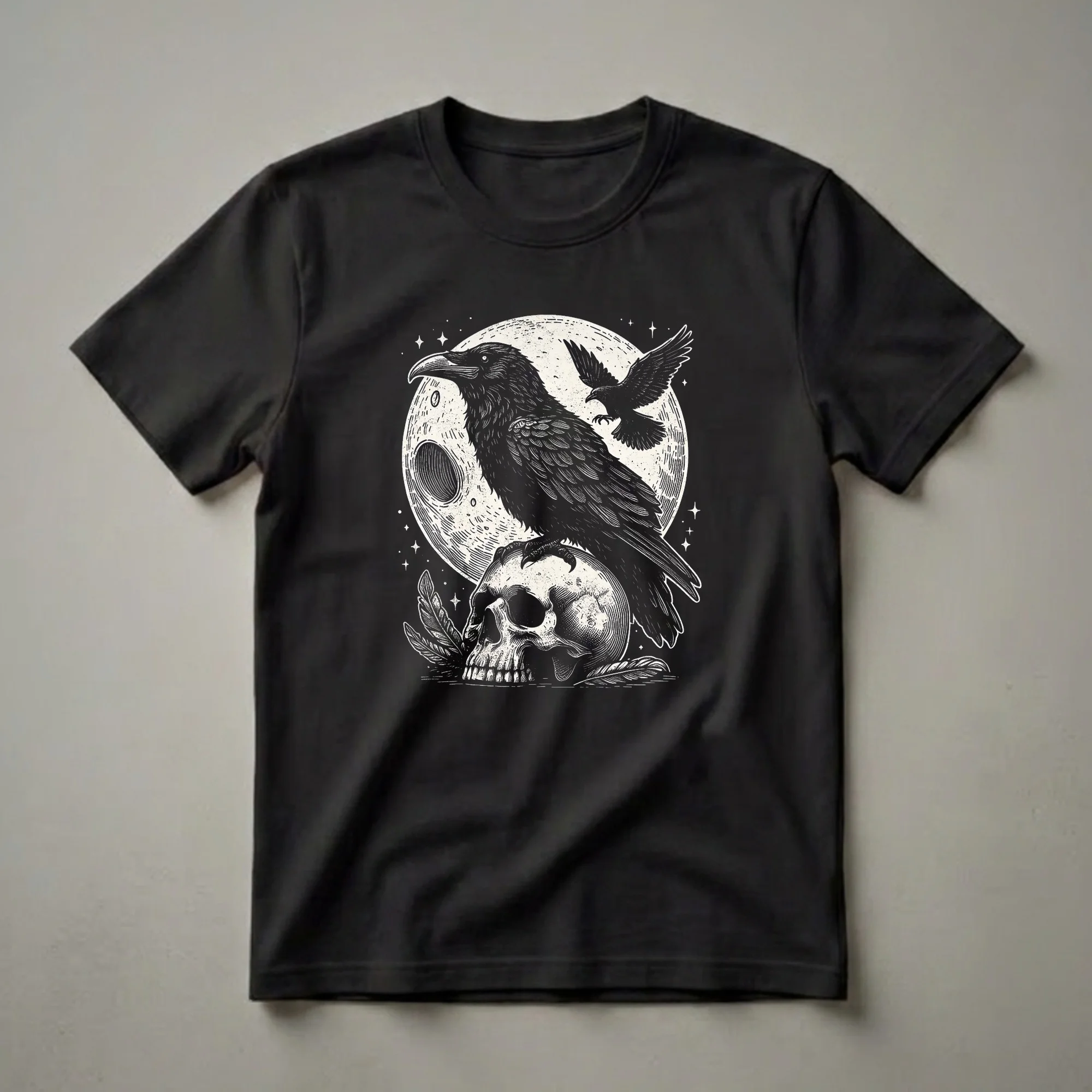 Black graphic t-shirt featuring a linocut-style illustration of a raven on a skull with a moon and stars in the background.