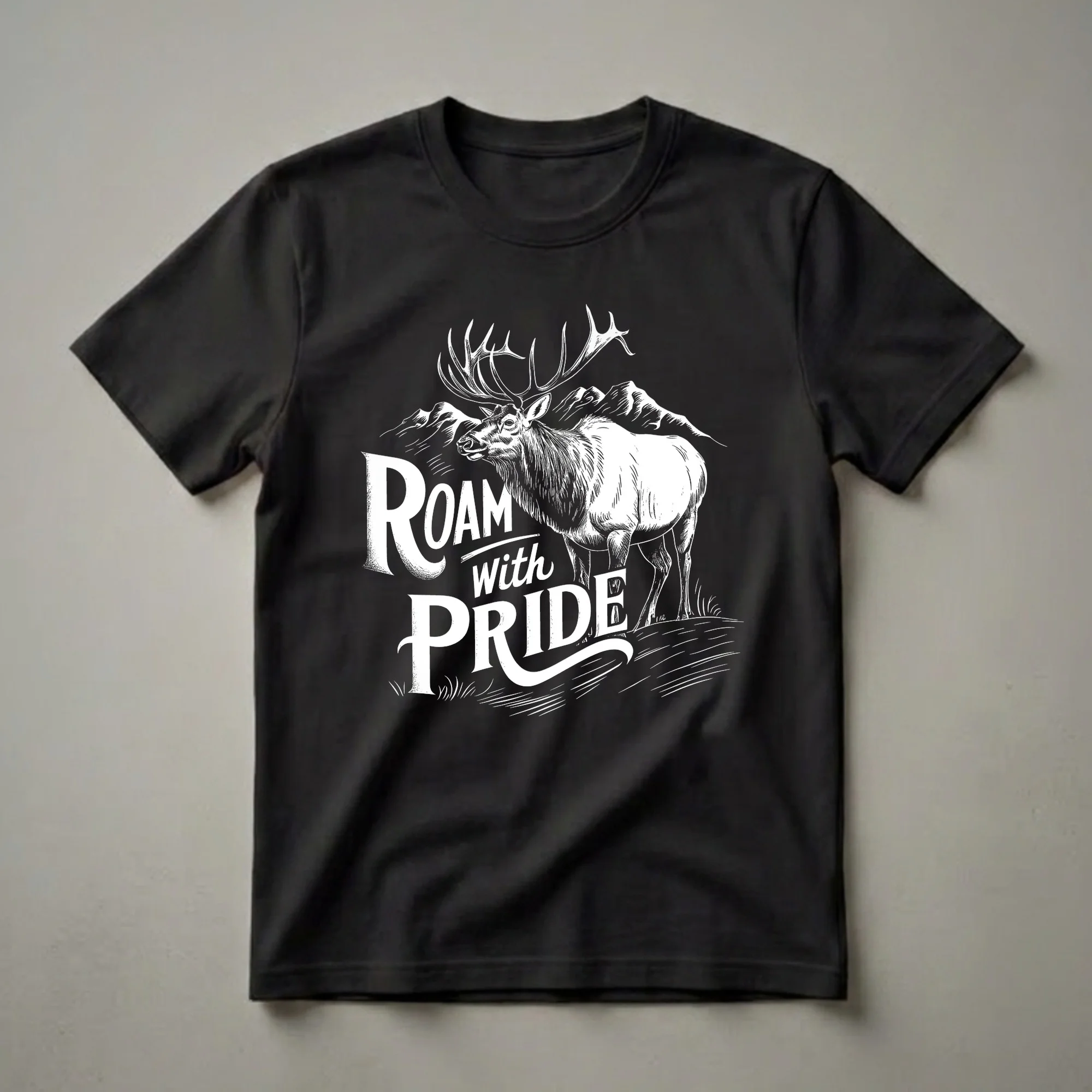 Black t-shirt with a white graphic of a bull elk with large antlers, mountains in the background, and the words 'Roam with Pride'.
