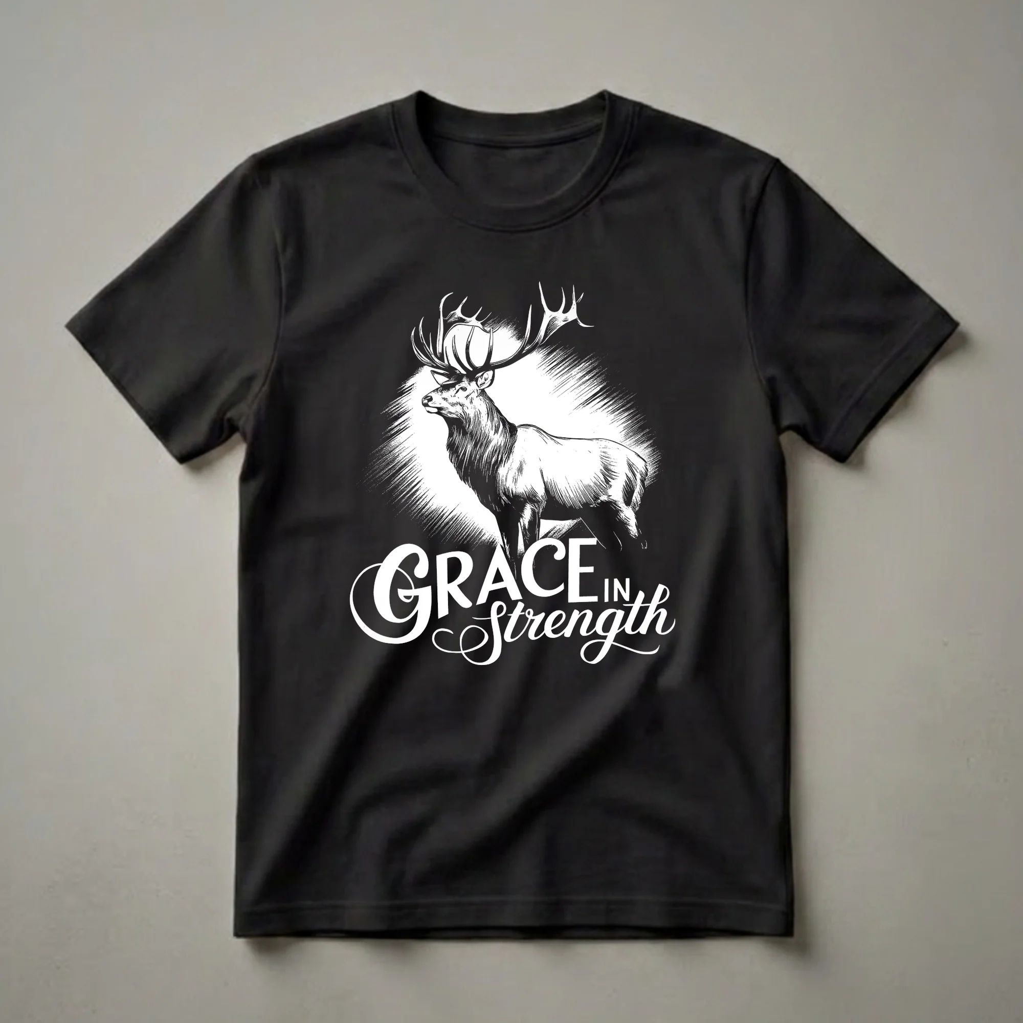 Black graphic t-shirt featuring a white illustration of a stag with large antlers and the text 'Grace in Strength' below, set against a textured background.